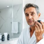 Man applying luxury anti-aging cream to face